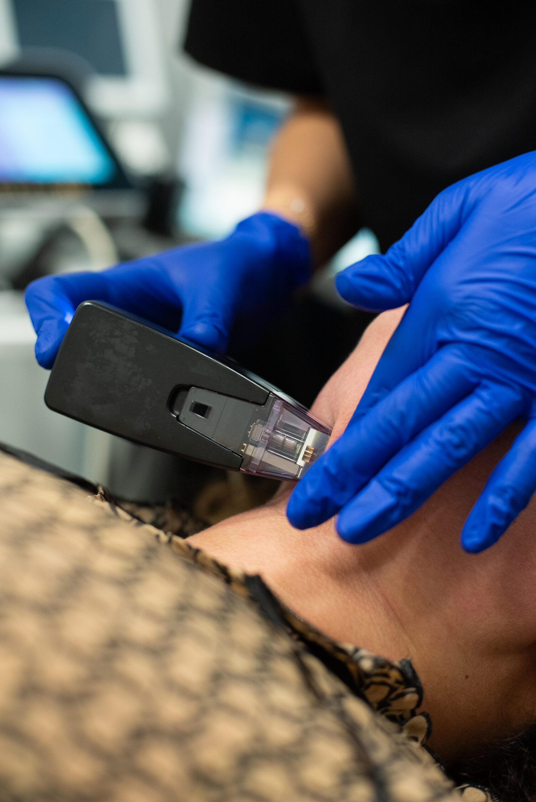 a person using a device to remove a person's neck